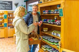 a man and a woman standing in a store shelf at Genholter Hof in Brüggen