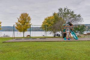 a park with a playground with a slide at Pet-Friendly Honeoye Cottage Rental Walk to Lake! in Honeoye
