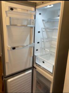an empty refrigerator with its door open in a kitchen at Boutique Zimmer Privat 1-4 Personen in Frankfurt/Main