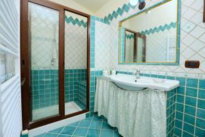 a bathroom with a sink and a shower at Villa Paradisea in Bacoli