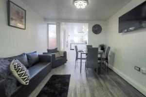 a living room with a couch and a dining room at (S4) Beautiful Studio Close To a Tube Station in Harrow on the Hill
