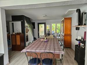 a kitchen with a table and chairs in a room at Vaste maison Fouras 15 pers 6 chbres meublé 3* in Fouras
