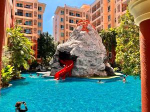 a water slide in a pool at a resort at Seven Seas Condo Resort Jomtien Loft in Jomtien Beach