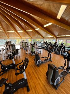 a gym with rows of exercise bikes and treadmills at Havellandhalle Resort in Seeburg