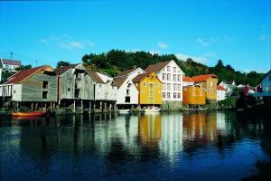 a group of houses next to a body of water at Jøssingfjord Apartments in Sokndal