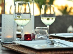 two glasses of white wine sitting on a table at Villa Rupert - 3 Bedrooms private pool WIFI AC in Tías