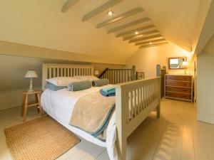 a bedroom with a bed and a dresser at Pail End in Brassington