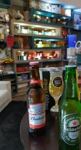 two bottles of beer sitting on a table with a glass at HOTEL MILANO in Sorocaba