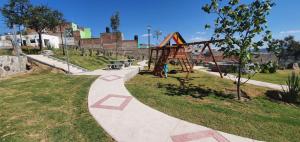 a park with a playground with a swing at Beautiful and modern apartment in Tonalá