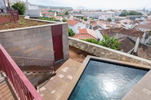 a swimming pool on the balcony of a house at AngrA + in Angra do Heroísmo