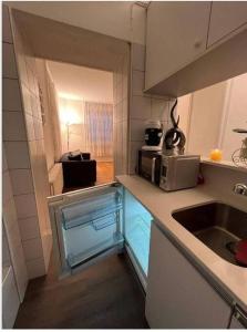 a small kitchen with a sink and a microwave at Appartamento di Vacanze in Muralto