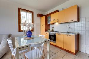 a kitchen with a glass table and a counter top at A casa di Anna in San Miniato