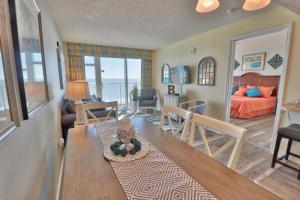 a living room with a dining table and a living room at Captivating oceanfront condo, with great views, Beachfront building, wifi and po in Myrtle Beach