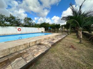 a swimming pool in a yard with a palm tree at Trou aux Biches Apartment in Trou aux Biches