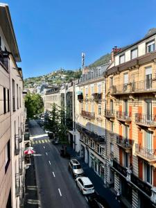 蒙特勒的住宿－appartement Montreux centre lac，享有拥有建筑和汽车的城市街道的景色