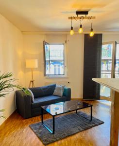 a living room with a couch and a coffee table at appartement Montreux centre lac in Montreux