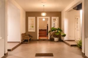 a hallway of a home with a potted plant at Kingsman House in Kandy