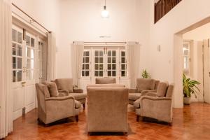 a living room with four chairs and a couch at Kingsman House in Kandy