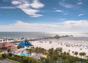 an aerial view of a beach with a playground and a pier at The Salty Cove IRB in Clearwater Beach