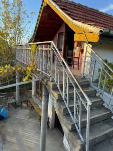 a staircase leading to a house with a porch at Къща до Казанлък 2 Стаи 3 Легла, Няма Ток и Вода, на Самомениджмънт in Kazanlŭk