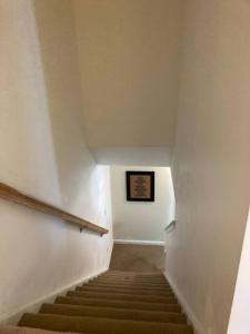 a staircase in a building with a picture on the wall at Midtown Harrisburg Townhouse in Harrisburg