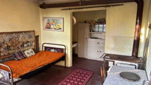 a small room with a bed and a kitchen at Къща до Казанлък 2 Стаи 3 Легла, Няма Ток и Вода, на Самомениджмънт in Kazanlŭk