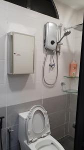 een badkamer met een wit toilet en een douche bij Sri Lagenda Apartment Langkawi in Kuah
