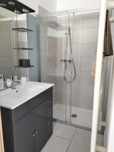 a bathroom with a shower and a sink and a tub at Gîte Les Rapières in Gordes