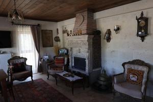 sala de estar con chimenea y TV en UCHI Cappadocia, en Uchisar