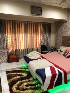 a bedroom with a large bed with a rug at The Luxurious Haven-Lokhandwala in Mumbai