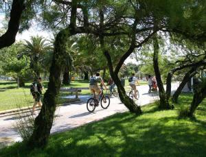 people riding bikes on a path in a park at #2 Studio # Place charmante in Toulon