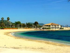 a view of a beach with a house in the background at #2 Studio # Place charmante in Toulon