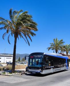 a bus is parked next to a palm tree at #2 Studio # Place charmante in Toulon