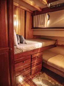 a bedroom with two bunk beds on a boat at Wooden Boat- La Goletta in Barcelona