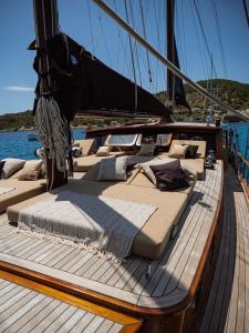 a group of beds on the deck of a boat at Wooden Boat- La Goletta in Barcelona