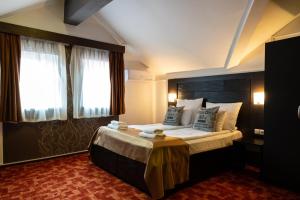 a bedroom with a large bed with a large window at VILA COMO EN CASA - FREE PARKING in Sarajevo