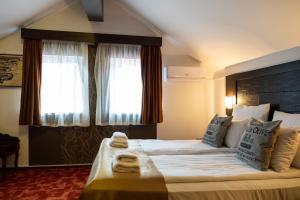 a hotel room with a large bed with towels on it at VILA COMO EN CASA - FREE PARKING in Sarajevo