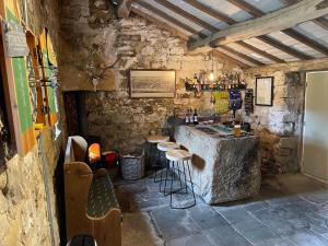 a stone room with a bar with stools in it at The Nook in Whitby