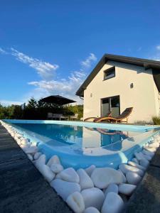 a swimming pool with a house in the background at Domek Viking in Gródek Nad Dunajcem