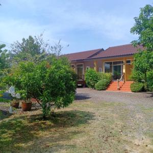 a house with a garden in front of it at Minton Resort มิลตั้น รีสอร์ท in Ban Kohong