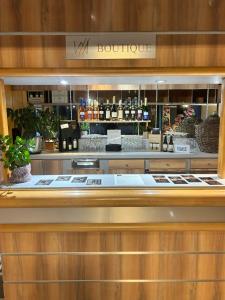 a bar in a store with a counter with alcohol at Hôtel Particulier LE MAS DES MARAIS in Machecoul