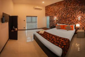 sypialnia z dużym łóżkiem w pokoju ze ścianą w obiekcie D Plus B&B Negombo w Negombo