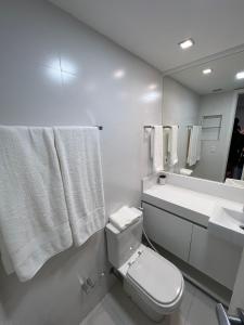a bathroom with a toilet and a sink and a mirror at Ipanema Flat - Vieira Souto 500 in Rio de Janeiro