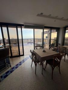 a table and chairs in a room with a view of the ocean at Ipanema Flat - Vieira Souto 500 in Rio de Janeiro