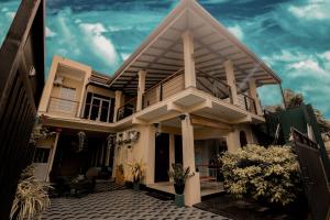 a house with a balcony and a blue sky at D Plus B&B Negombo in Negombo