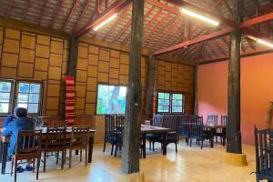 a person sitting at a table in a restaurant at Baan Tawai Lanna Resort in Hang Dong