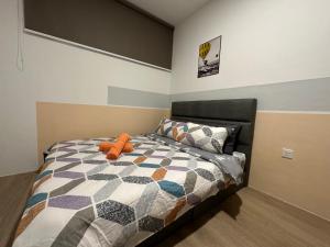 a bedroom with a bed with an orange stuffed animal on it at Wanderlust Homes @ Armadale Residence in Kuching +9 photos