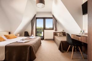 a hotel room with two beds and a window at Willa Gielatówka in Białka Tatrzańska