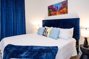 a bedroom with a bed with blue curtains at Mid-City Magic 3 in New Orleans