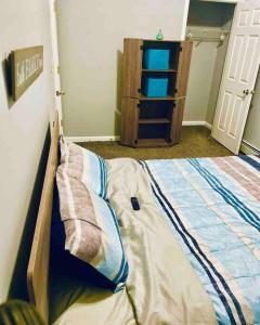 a bedroom with a bed and a book shelf at Cozy up with me! Longer stays! Free parking in Troy